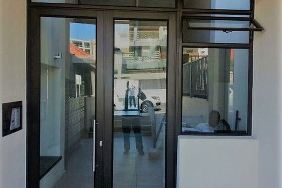 Aluminium framed bathroom door with frosted panel