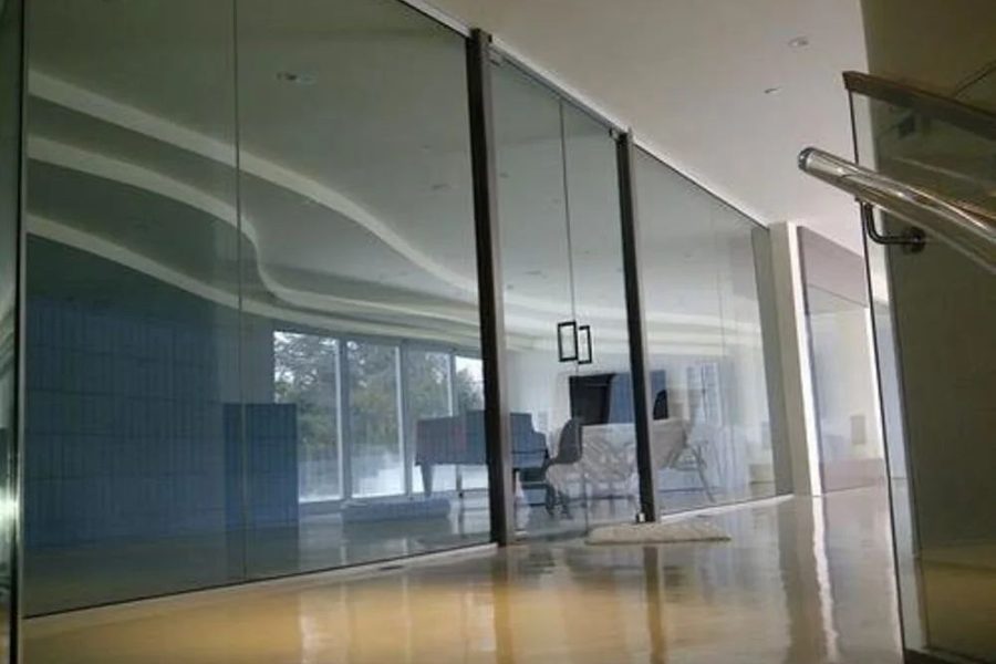 Frameless glass entrance door to a showroom