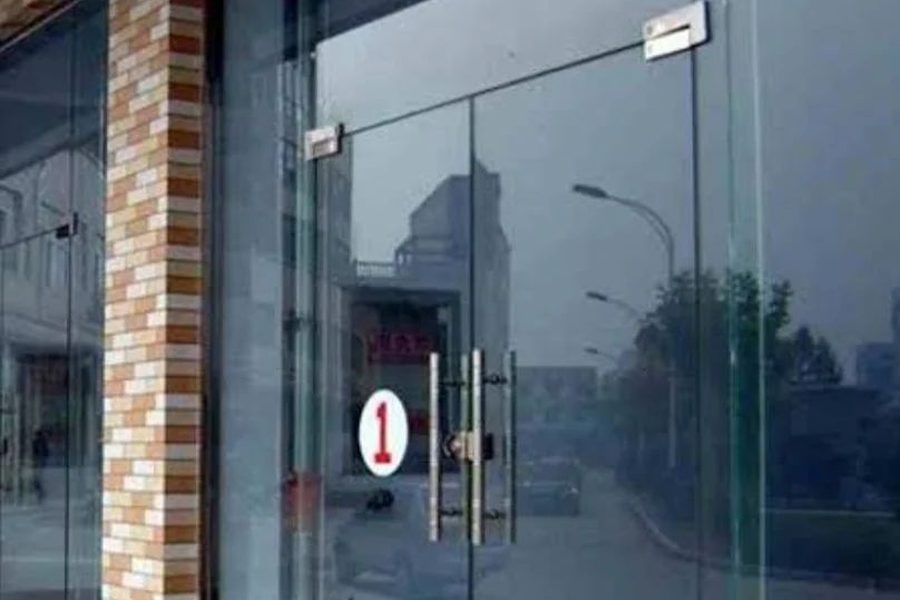 Frameless glass door with patch fittings in an office