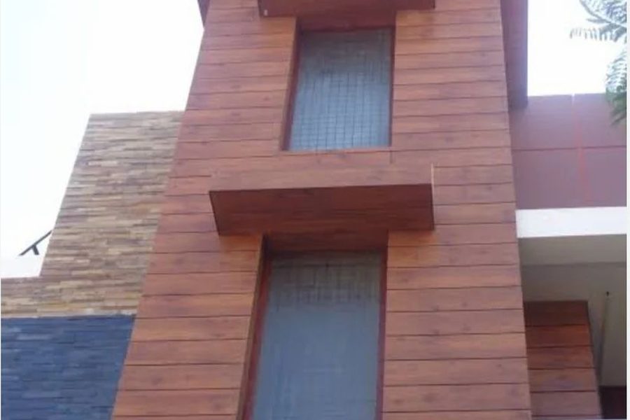 HPL clad entrance wall with a solid timber-effect finish