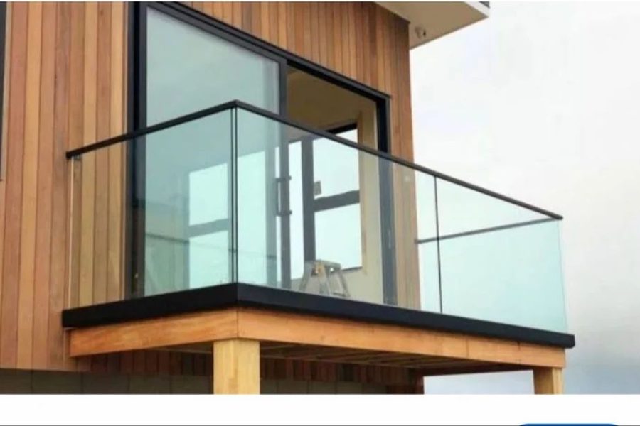 Glass railing set into a continuous aluminium base channel